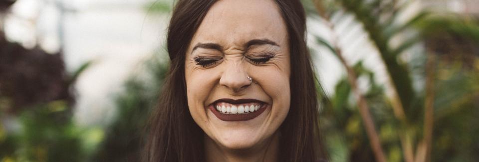 Woman laughing hysterically with closed eyes