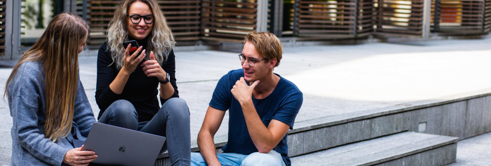 three people sitting talking with each other